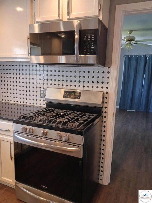 501 S Oak St, Versailles, MO 65084 - kitchen with stainless steel appliances, a ceiling fan, white cabinets, and dark wood finished floors