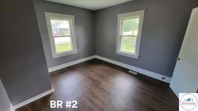501 S Oak St, Versailles, MO 65084 - unfurnished room featuring dark wood-type flooring and baseboards
