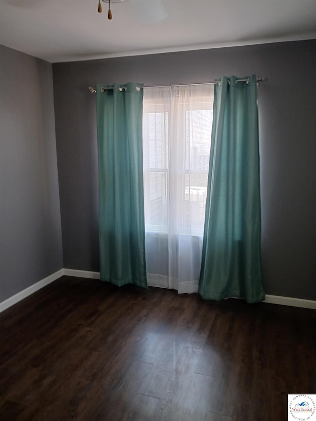 501 S Oak St, Versailles, MO 65084 - spare room featuring dark wood finished floors and baseboards