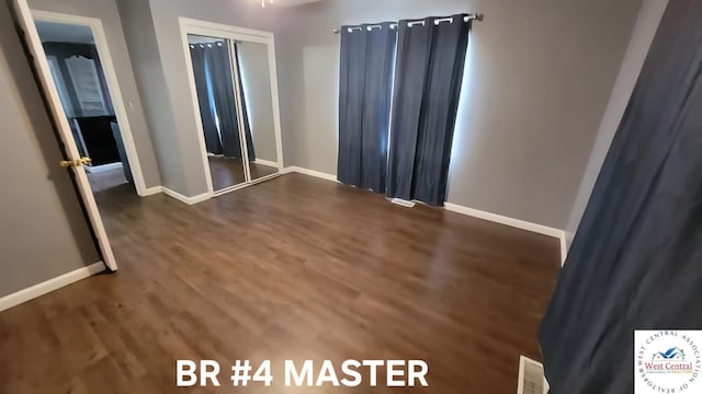 501 S Oak St, Versailles, MO 65084 - unfurnished bedroom with wood finished floors and a closet