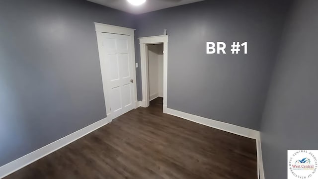 501 S Oak St, Versailles, MO 65084 - spare room featuring dark wood-style flooring and baseboards