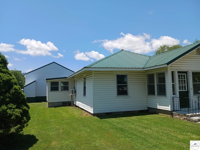 501 S Oak St, Versailles, MO 65084 - view of property exterior featuring a lawn, a metal roof, and crawl space
