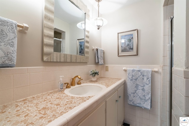 7020 Walnut Cir, Sedalia, MO 65301 - full bathroom featuring an enclosed shower, vanity, a wainscoted wall, and tile walls