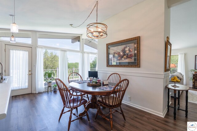 7020 Walnut Cir, Sedalia, MO 65301 - dining room featuring an inviting chandelier, dark wood-style flooring, lofted ceiling, and baseboards