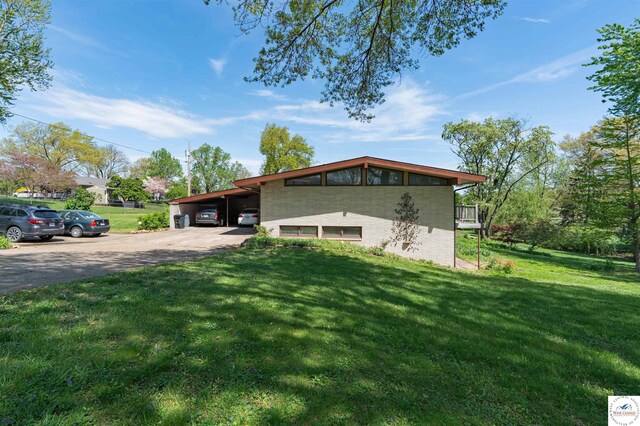 7020 Walnut Cir, Sedalia, MO 65301 - exterior space with a lawn, a carport, and concrete driveway