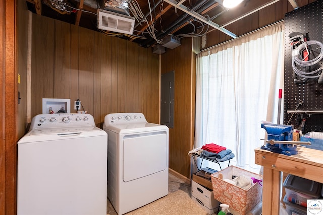 7020 Walnut Cir, Sedalia, MO 65301 - washroom featuring electric panel, visible vents, wood walls, independent washer and dryer, and laundry area