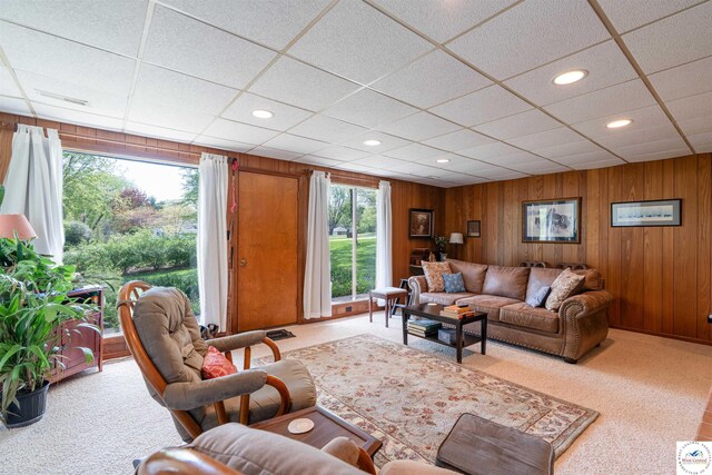 7020 Walnut Cir, Sedalia, MO 65301 - carpeted living room with recessed lighting, a paneled ceiling, and wood walls