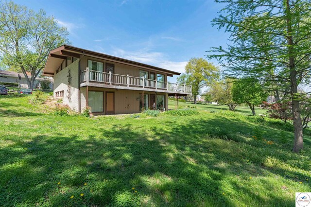 7020 Walnut Cir, Sedalia, MO 65301 - rear view of property featuring a wooden deck and a yard