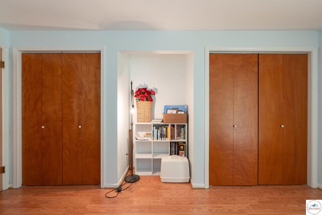 7020 Walnut Cir, Sedalia, MO 65301 - bedroom featuring multiple closets, wood finished floors, and baseboards