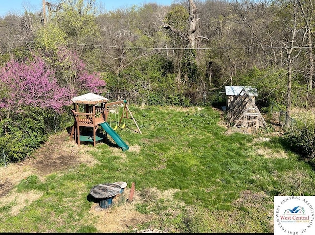 607 Laurel St, Warrensburg, MO 64093 - view of yard featuring a forest view and a playground