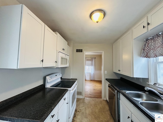 607 Laurel St, Warrensburg, MO 64093 - kitchen with a wealth of natural light, visible vents, white appliances, and a sink