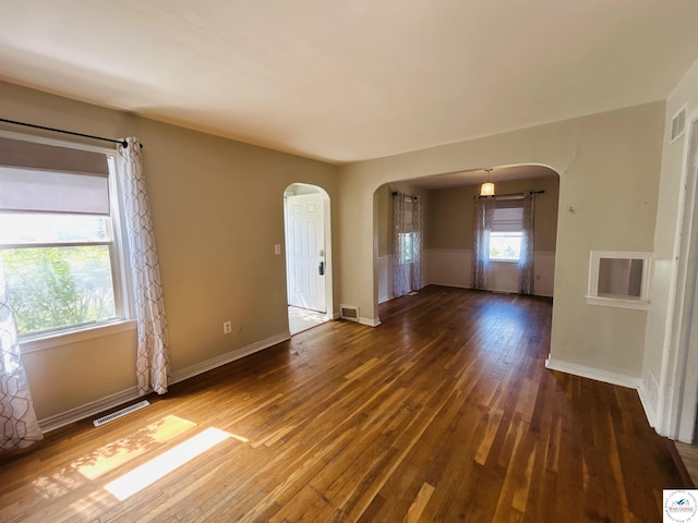 607 Laurel St, Warrensburg, MO 64093 - unfurnished room with arched walkways and wood finished floors
