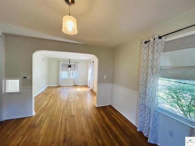 607 Laurel St, Warrensburg, MO 64093 - empty room with arched walkways and wood finished floors