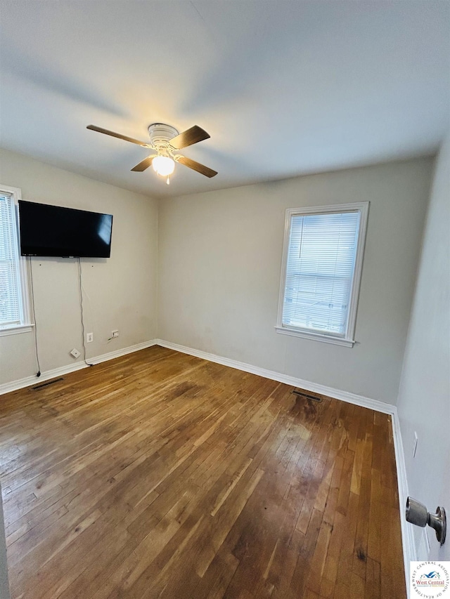 607 Laurel St, Warrensburg, MO 64093 - spare room with hardwood / wood-style flooring, visible vents, a ceiling fan, and baseboards