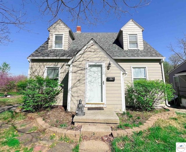 607 Laurel St, Warrensburg, MO 64093 - cape cod-style house featuring roof with shingles and a chimney