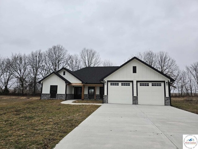61 NW 247th Rd, Clinton, MO 64735 - modern farmhouse with driveway, board and batten siding, stone siding, a front lawn, and a garage