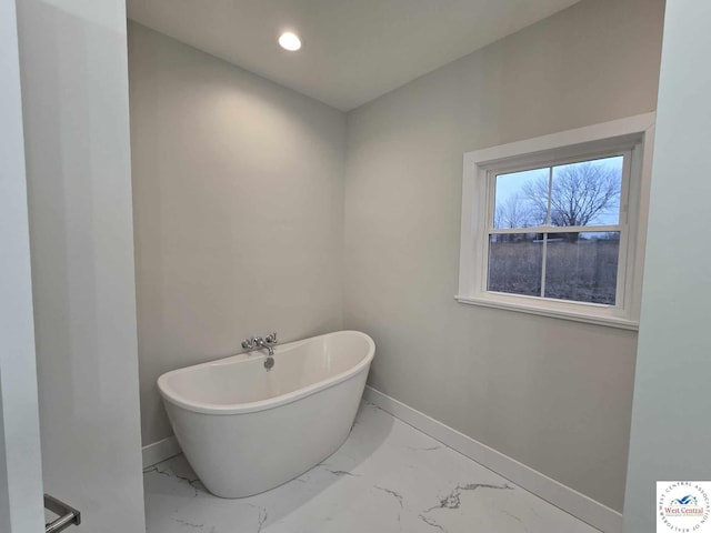 61 NW 247th Rd, Clinton, MO 64735 - bathroom with recessed lighting, marble finish floor, a freestanding tub, and baseboards