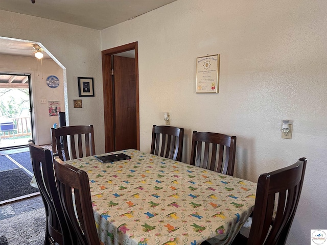 dining area featuring a textured wall