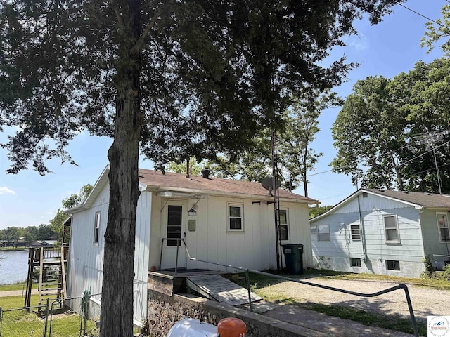 rear view of property with fence and board and batten siding
