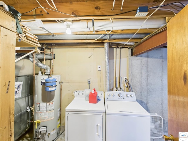laundry area featuring gas water heater and separate washer and dryer