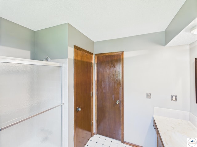 bathroom with a stall shower and vanity