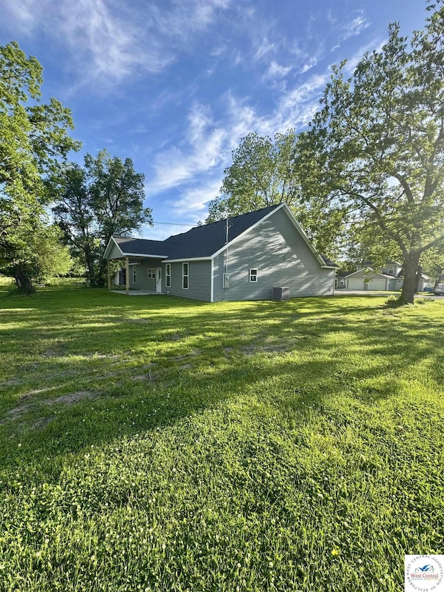 rear view of property featuring a yard