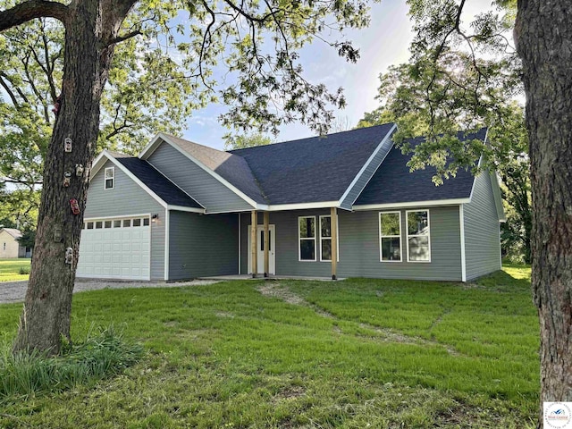 single story home featuring an attached garage, a front lawn, and a shingled roof