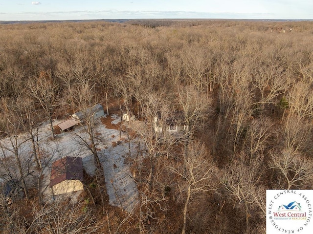 birds eye view of property with a view of trees