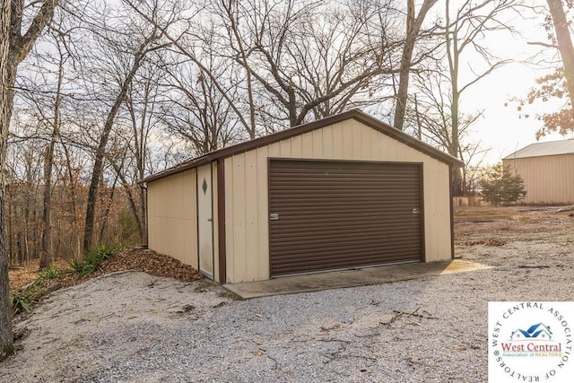 detached garage with gravel driveway