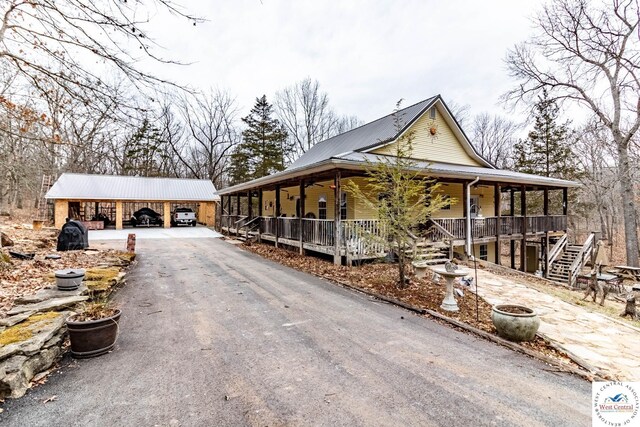 25733 Macks Ave, Warsaw, MO 65355 - exterior space with a porch, stairs, metal roof, and a carport