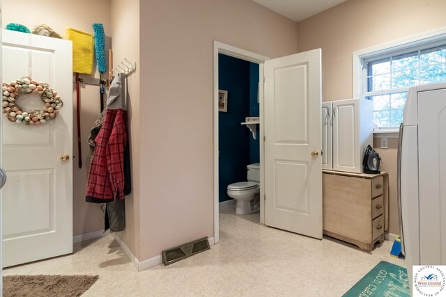 25733 Macks Ave, Warsaw, MO 65355 - bathroom with washer / clothes dryer, visible vents, baseboards, toilet, and tile patterned floors