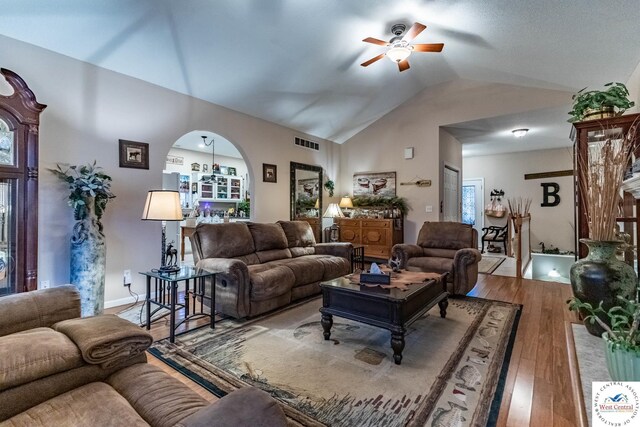 25733 Macks Ave, Warsaw, MO 65355 - living area with visible vents, ceiling fan, arched walkways, vaulted ceiling, and wood finished floors