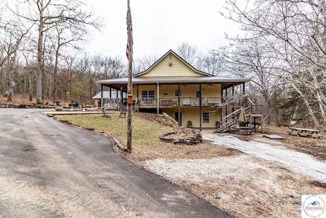 25733 Macks Ave, Warsaw, MO 65355 - country-style home featuring a porch, a ceiling fan, metal roof, and stairs