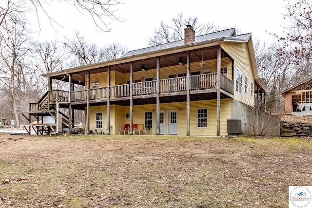 25733 Macks Ave, Warsaw, MO 65355 - rear view of house featuring a chimney, stairway, metal roof, a wooden deck, and cooling unit