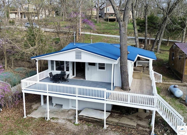 rear view of property with a wooden deck