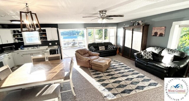 19242 Quail Rd, Warsaw, MO 65355 - living area featuring a ceiling fan, light carpet, and a textured ceiling