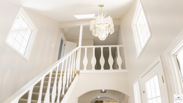 1903 E Alfresco St, Clinton, MO 64735 - stairway with a high ceiling, plenty of natural light, a chandelier, and a skylight