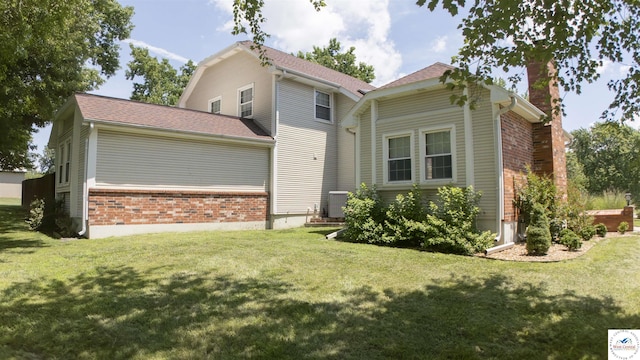 1903 E Alfresco St, Clinton, MO 64735 - view of front of home with a chimney, a front yard, and brick siding