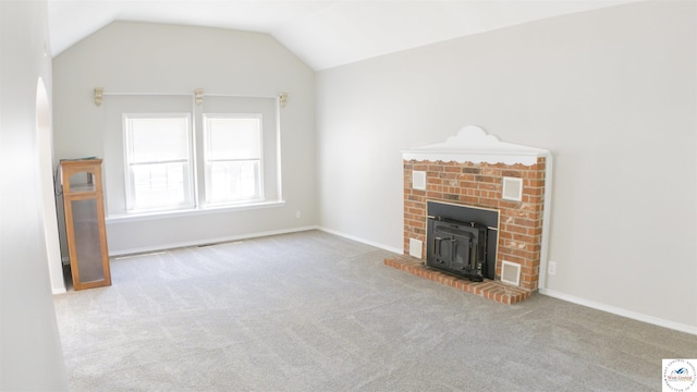 1903 E Alfresco St, Clinton, MO 64735 - unfurnished living room with carpet floors, vaulted ceiling, and a wood stove