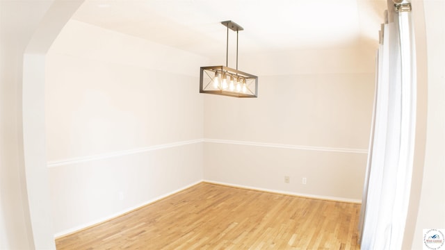 1903 E Alfresco St, Clinton, MO 64735 - empty room featuring wood finished floors and arched walkways