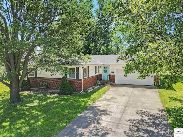 view of front of property with brick siding, concrete driveway, a garage, and a front lawn