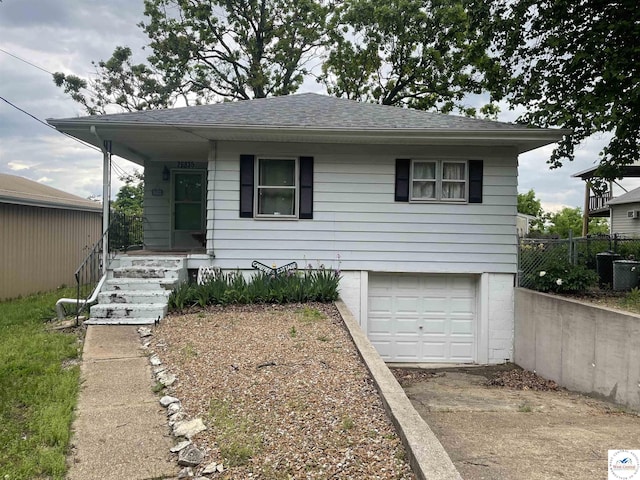 26835 Carefree Ln, Warsaw, MO 65355 - view of front of house with a garage, driveway, a porch, and roof with shingles