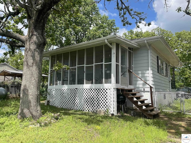 26835 Carefree Ln, Warsaw, MO 65355 - view of home's exterior with a sunroom