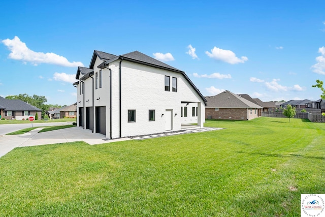 rear view of property featuring driveway, a garage, and a residential view