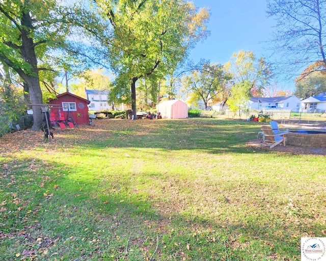view of yard featuring a storage shed and an outbuilding