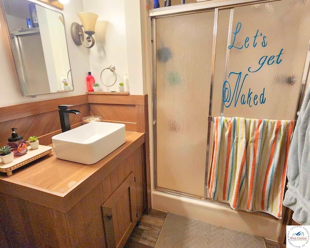 full bathroom with a stall shower and vanity