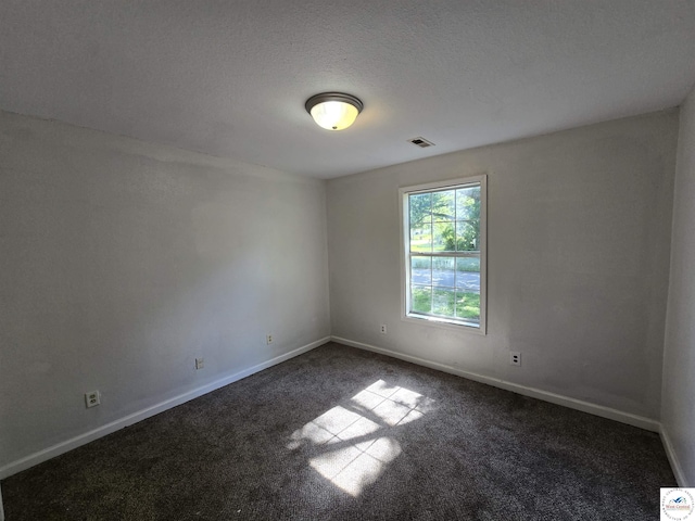 511 S Carter St, Clinton, MO 64735 - unfurnished room featuring dark carpet and a textured ceiling