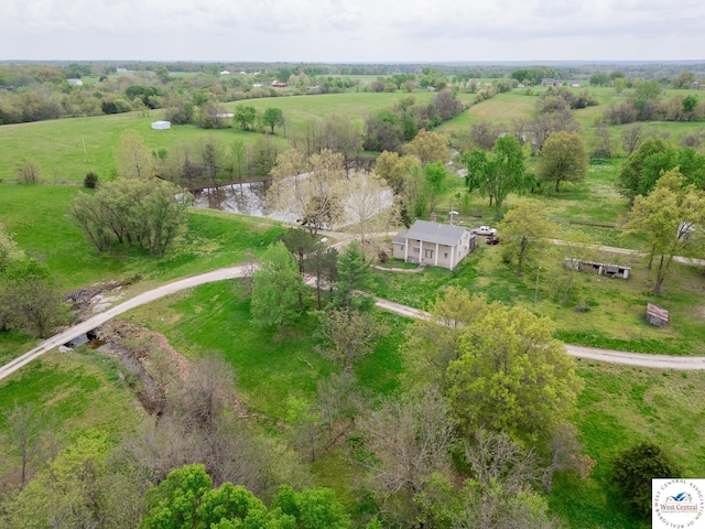 birds eye view of property featuring a rural view and a water view