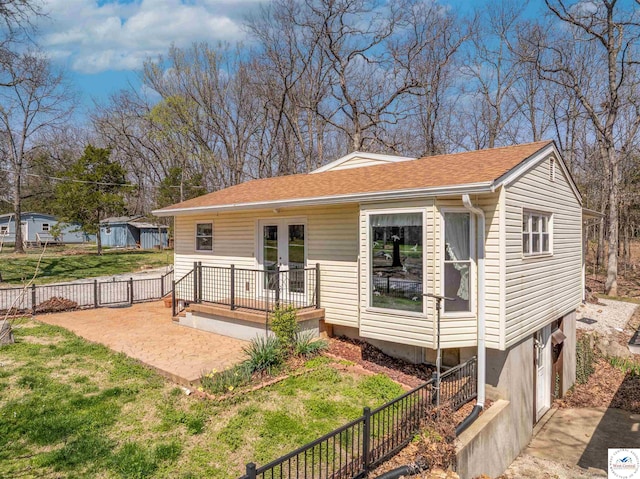 13913 Sable Cir, Warsaw, MO 65355 - back of house with fence, a wooden deck, roof with shingles, french doors, and a lawn
