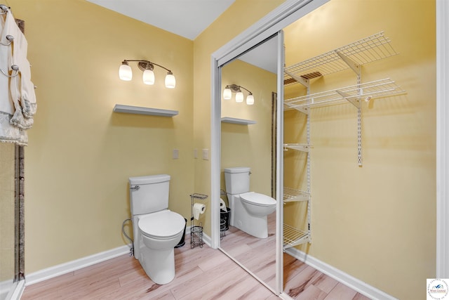 13913 Sable Cir, Warsaw, MO 65355 - bathroom with toilet, wood finished floors, and baseboards